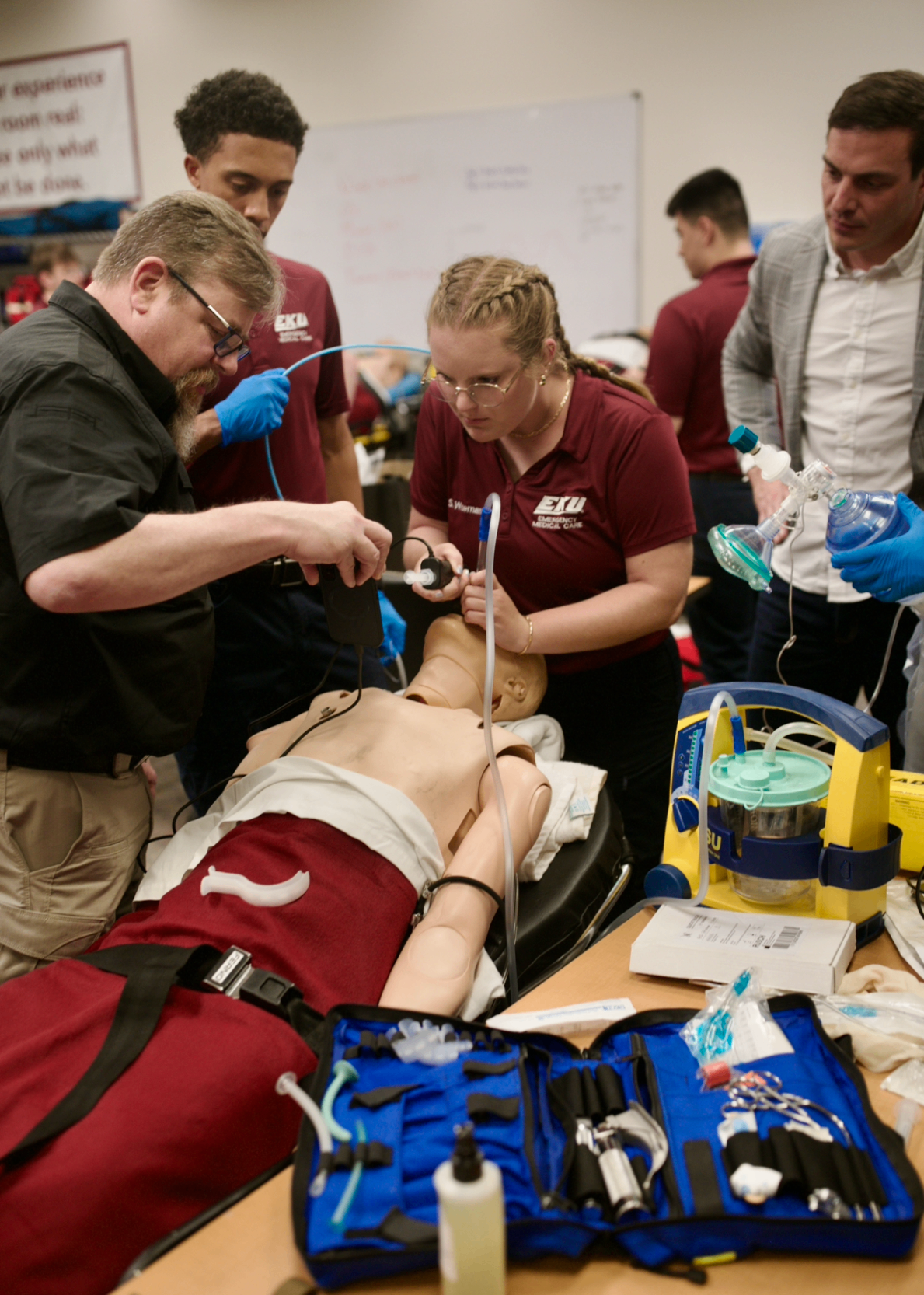 EKU EMC instructor and students performing hands-on airway intubation simulation with IntuBlade video laryngoscope